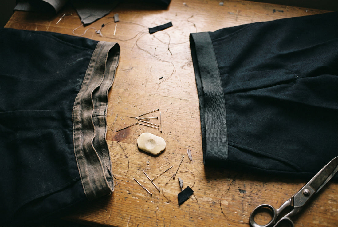 An old slack waistband beside a new taut one on a work table