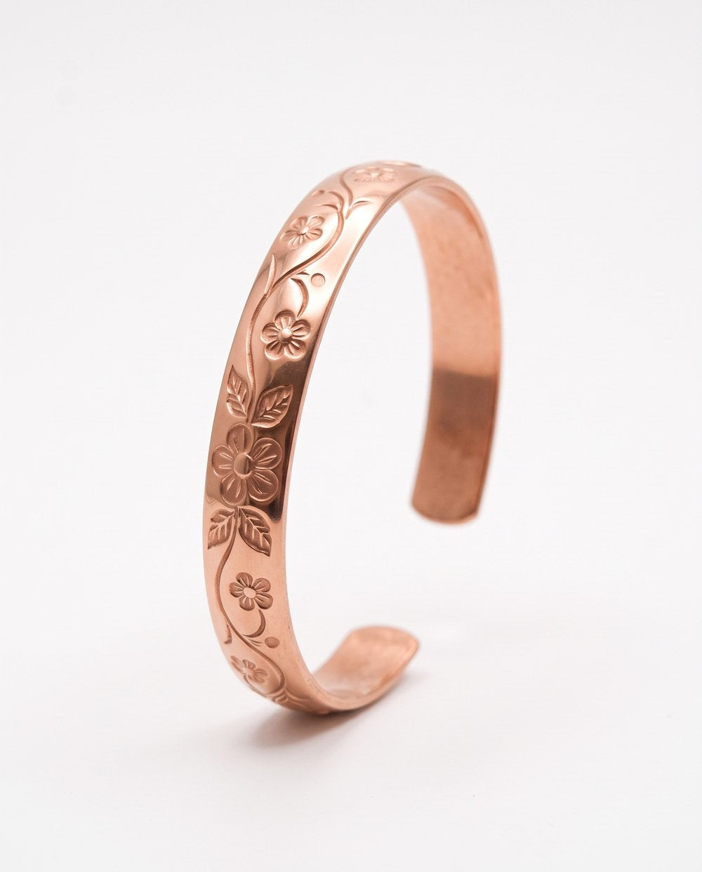 Solid copper cuff with an engraved floral vine