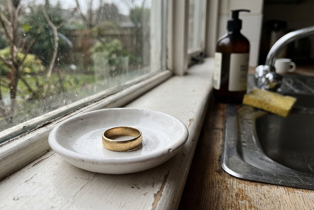 Her wedding band in a dish by the kitchen sink