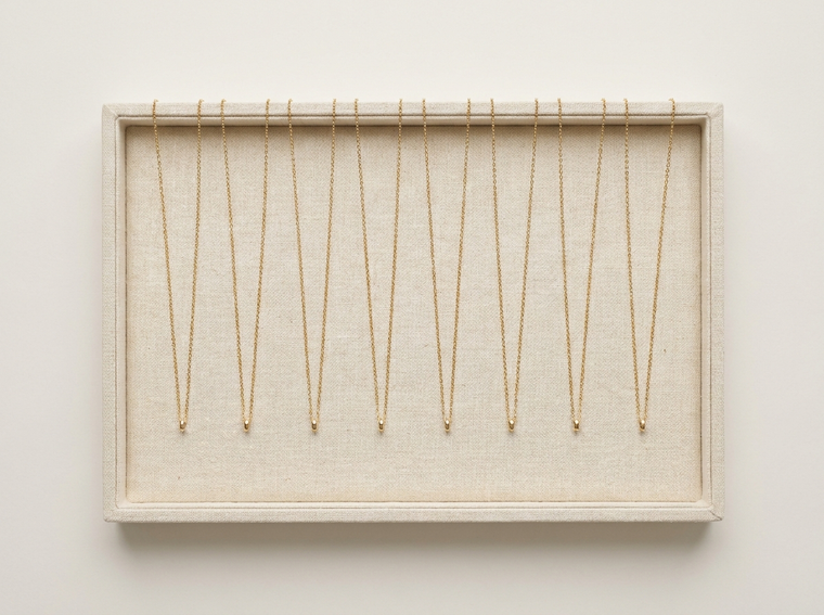 Eight identical gold necklaces, the whole run of one design