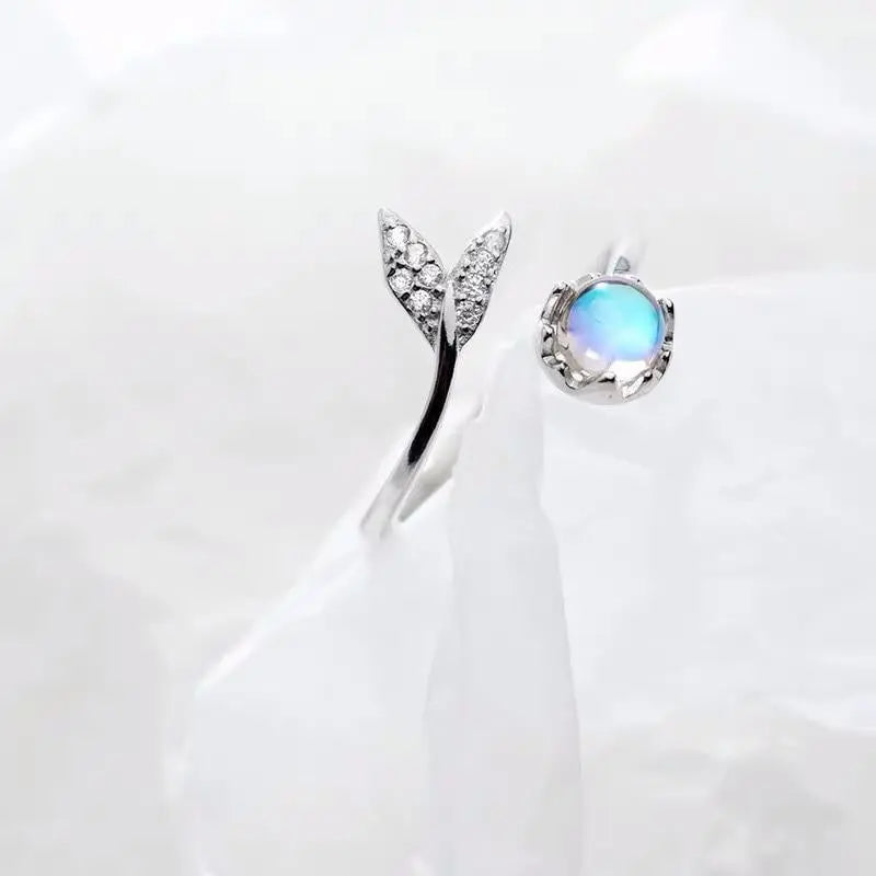 Adjustable ring with dolphin tail made of sterling silver and blue zirconium dioxide